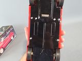 a person holding a toy car in their hand