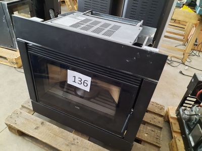 a black oven sitting on top of a pallet in a warehouse