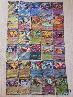 a pile of pokemon cards sitting on top of a table