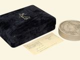a small box with a coin inside of it on a table