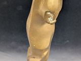 gold statue of a bear on a wooden base on a black background