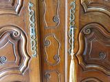 a close up of a wooden door with intricate carvings