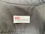 the label on the back of a jacket reads red valentino