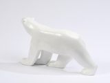 a white polar bear figurine sitting on a white surface