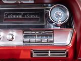 a red car dashboard with a clock and gauges on it