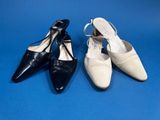 two pairs of black and white shoes on a blue background