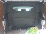 a white van with a door open and a bag of food in the back