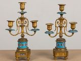 pair of antique brass candelabs with blue and gold decorations