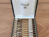 a box with a set of silverware in it on a wooden table