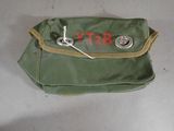 a small green bag with a pair of scissors in it