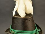 a black hat with a feather on top of it