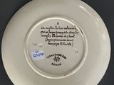 an image of a plate with a poem on it on a table