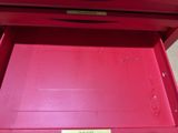 a red drawer with a sign on it that says there ' s no place to put something in it