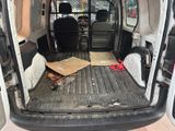 the back of a van with the door open and a box in the back of the van