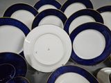 a lot of blue and white plates and bowls on the table