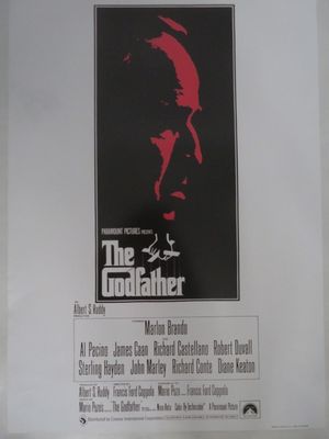 une image de l'affiche du film « Le Parrain » sur laquelle figure le visage d'un homme