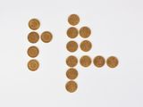 an image of a number of gold coins arranged in the shape of a man