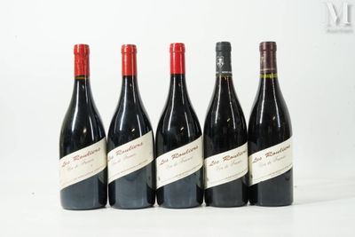six bottles of wine are lined up in a row on a white surface