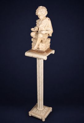 a statue of a man sitting on top of a pedestal