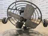 a metal fan that is sitting on the ground