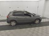 a picture of a grey car parked in a garage