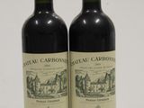 two bottles of red wine sitting next to each other on a table