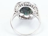 an image of a green tourmaline and diamond ring on a white background