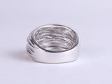 silver plated ring on a white surface with a white background