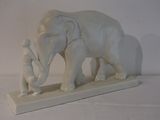 a statue of an elephant and a man standing next to each other