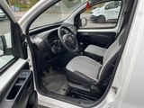 the interior of a car with the door open and the driver ' s seat down