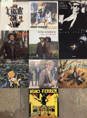 many different album covers on the wall of a room