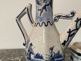 a blue and white tea pot and a cup on a table