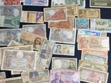 many different types of money on a black table