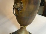 a lamp that is on a table with a lion head on it