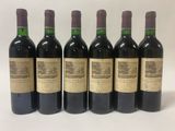 six bottles of wine are lined up in a row