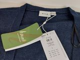 a close up of a blue shirt with a tag on it