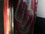 a soda machine that is sitting in a room