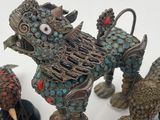 five figurines of a dog and four birds on a white surface