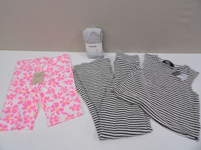 two pieces of clothing sitting on top of a table next to a cup of coffee