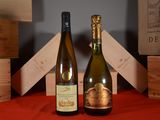 two bottles of wine sitting next to each other on a table