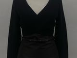 black long sleeved top with belt on a mannequin base
