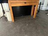 a wooden table with a drawer on top of it