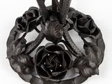 a metal table with a flower design on top of it