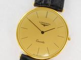a close up of a watch on a white surface with a black strap