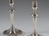 pair of silver candlesticks on a white background