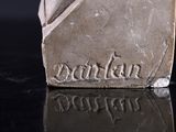 a close up of a small statue on a table