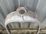 a close up of an old motorcycle headlight on the ground