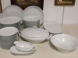 a lot of white plates and bowls on the table