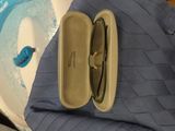a bag with a pair of glasses in it on a table