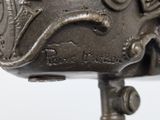 a close up of a metal object on a white surface